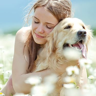 Woman Hugging dog with flowers